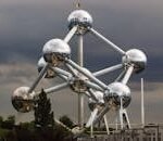 The Atomium in Brussels, Belgium, showcasing its unique steel spheres against a dramatic sky.